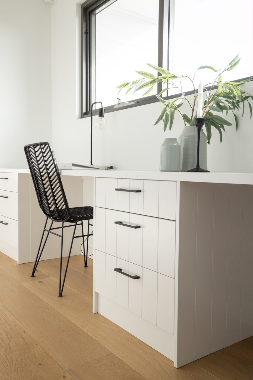 Stylish Office design; a black chair and lots of desk storage